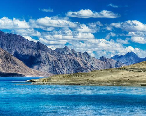 Mountains and Pangong tso (Lake). It is huge lake in Ladakh, altitude 4,350 m (14,270 ft). It is 134 km (83 mi) long and extends from India to Tibet. Leh, Ladakh, Jammu and Kashmir, India