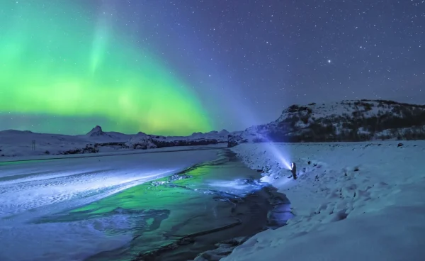 northern_lights_iceland_person_with_torch_jonatan_pie_unsplash_a3402caa84